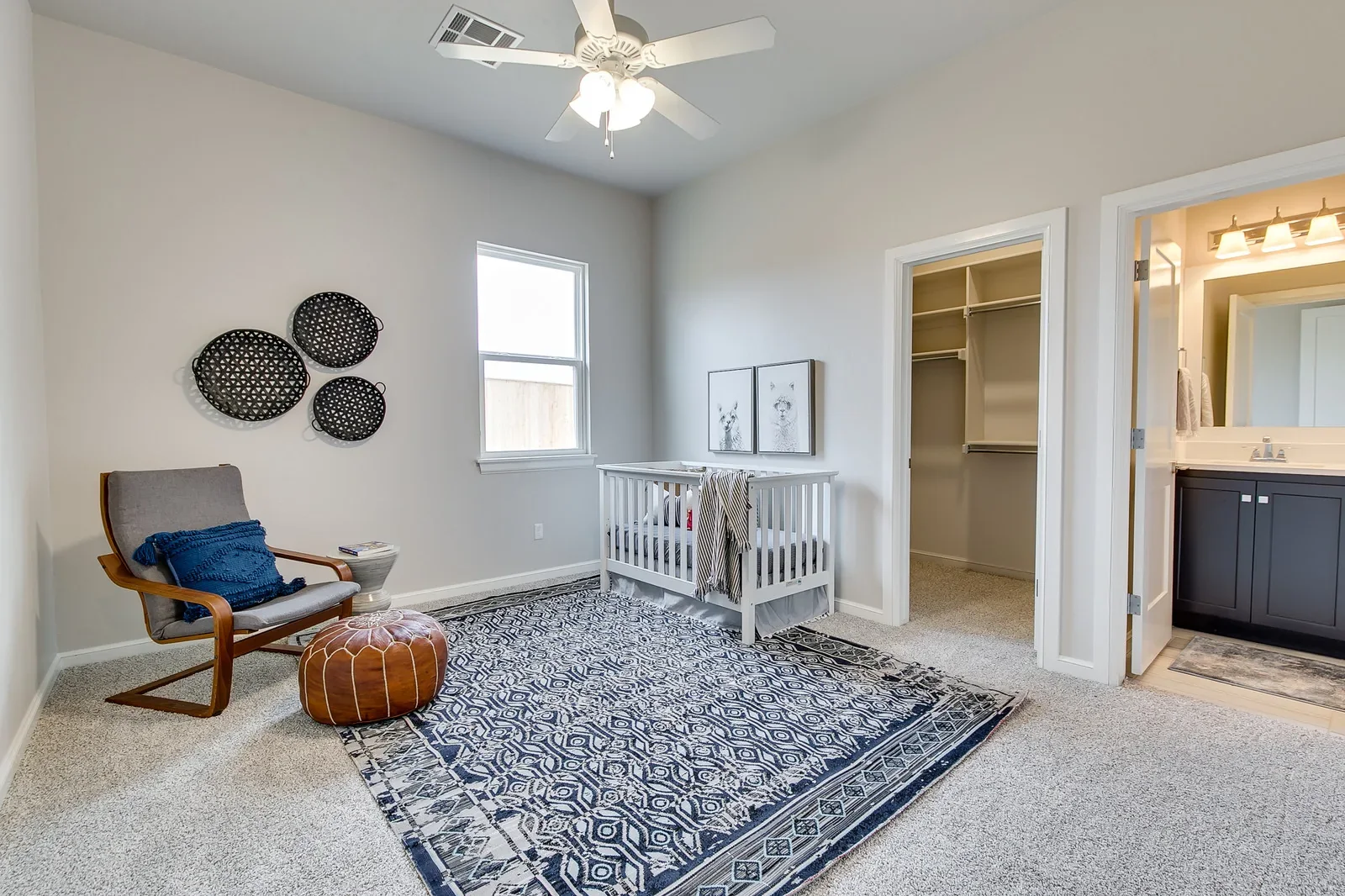 Nursery with reading chair, crib, and open closet
