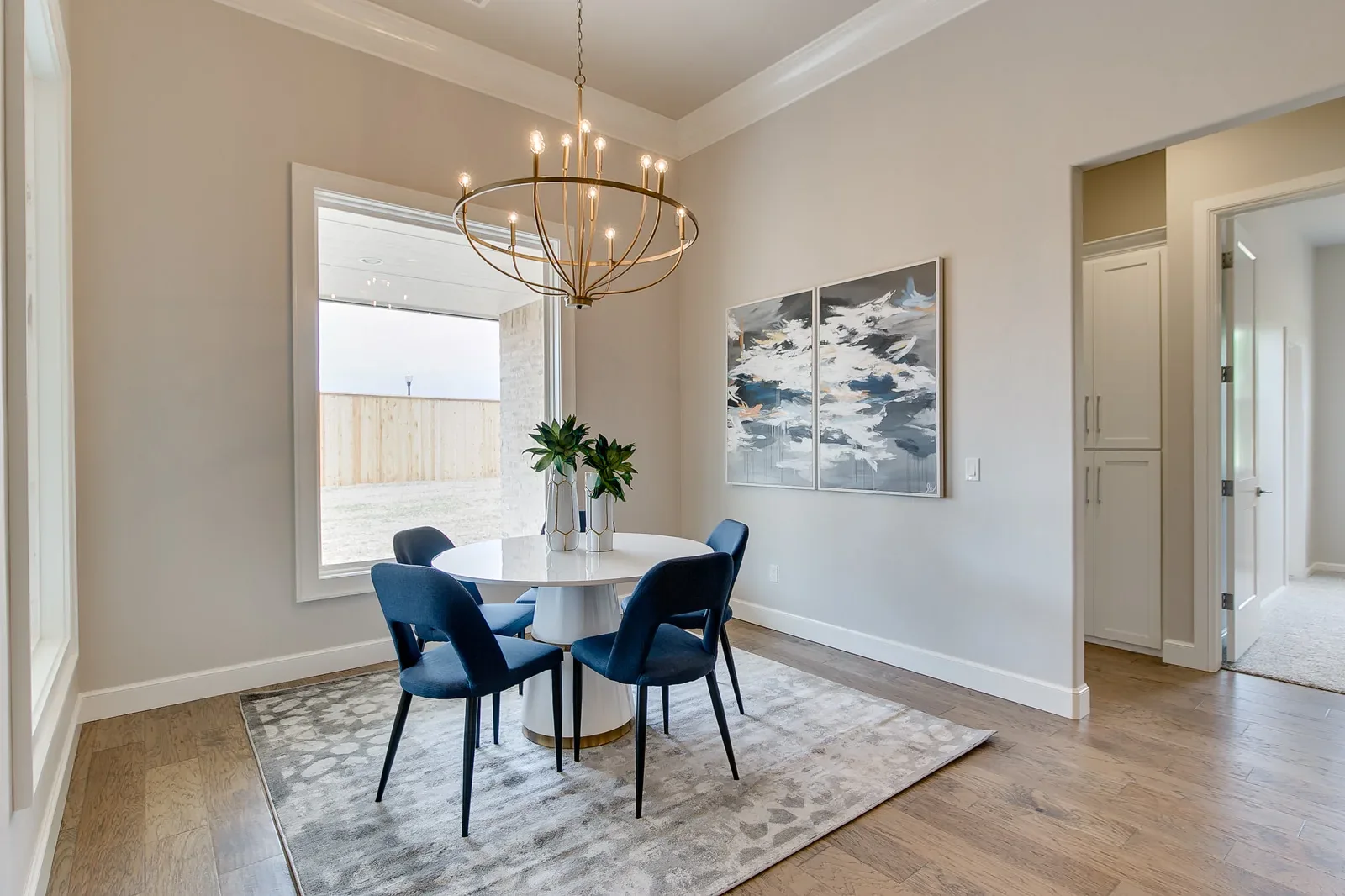 Dining room with round table and oversized metal chandelier
