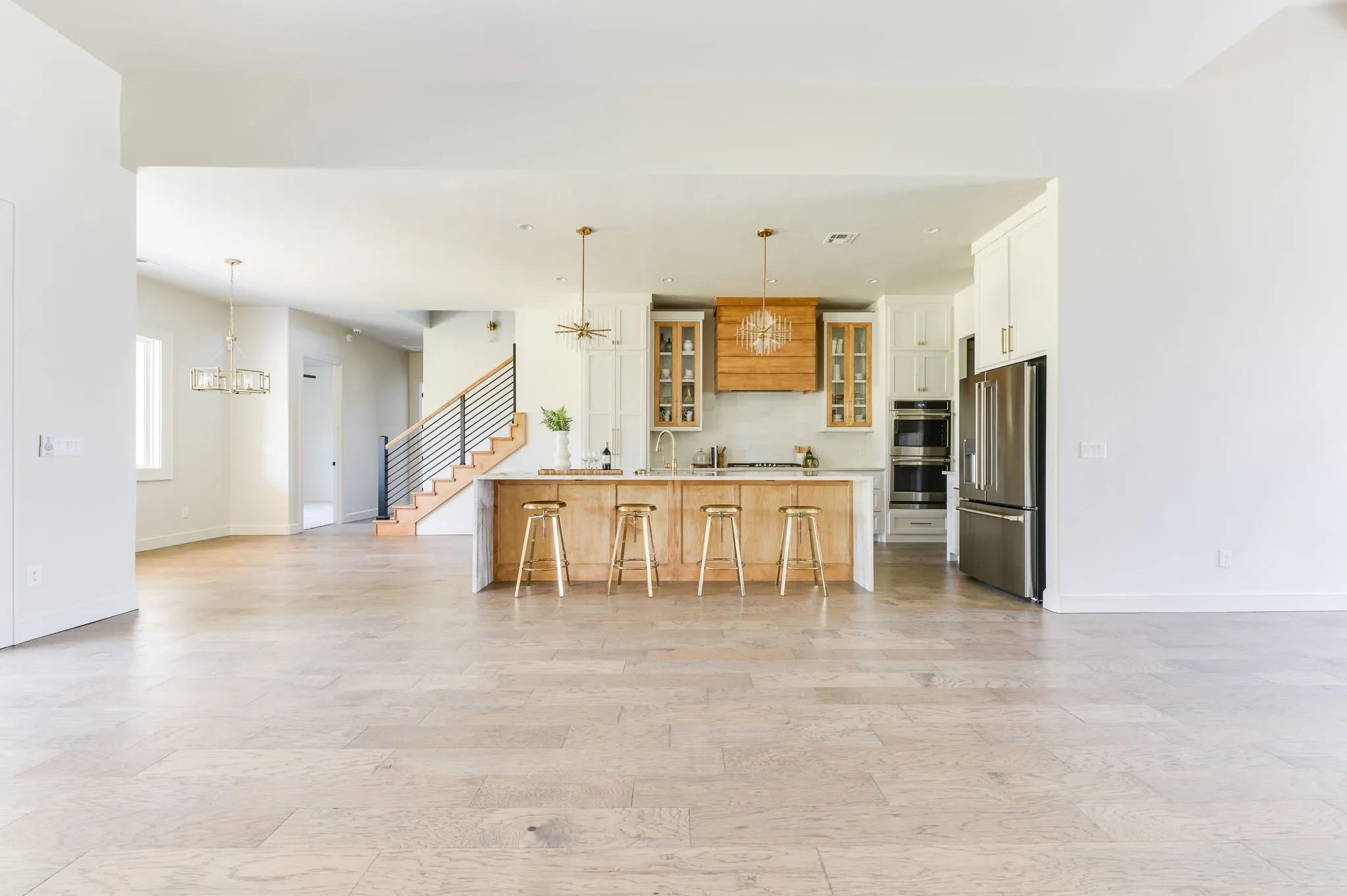 Open living area with the kitchen island and staircase beyond