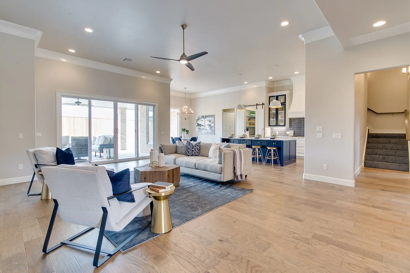 Open living room and navy-island kitchen with backyard views