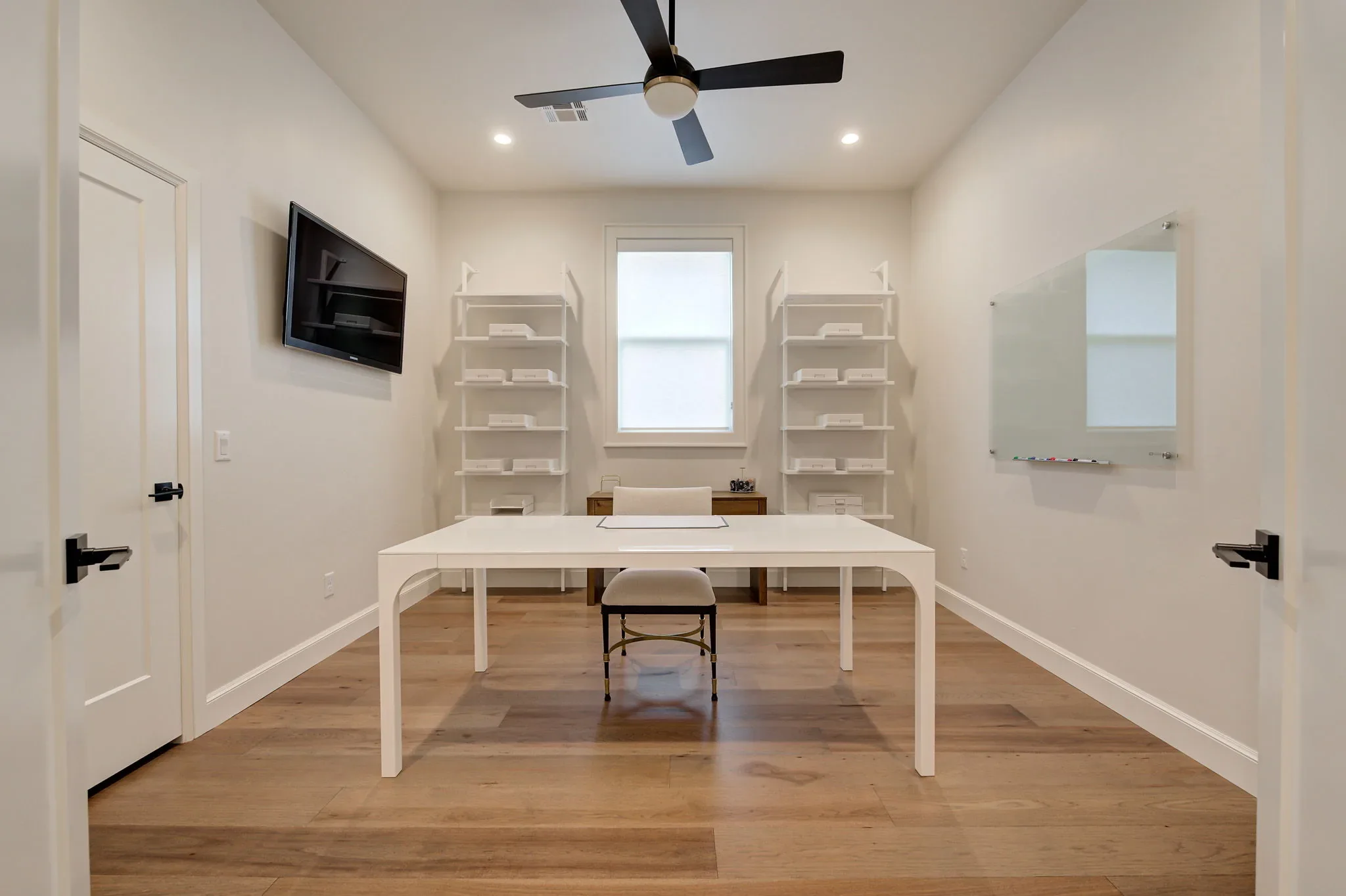 Upstairs craft room with worktable, shelving, and whiteboard