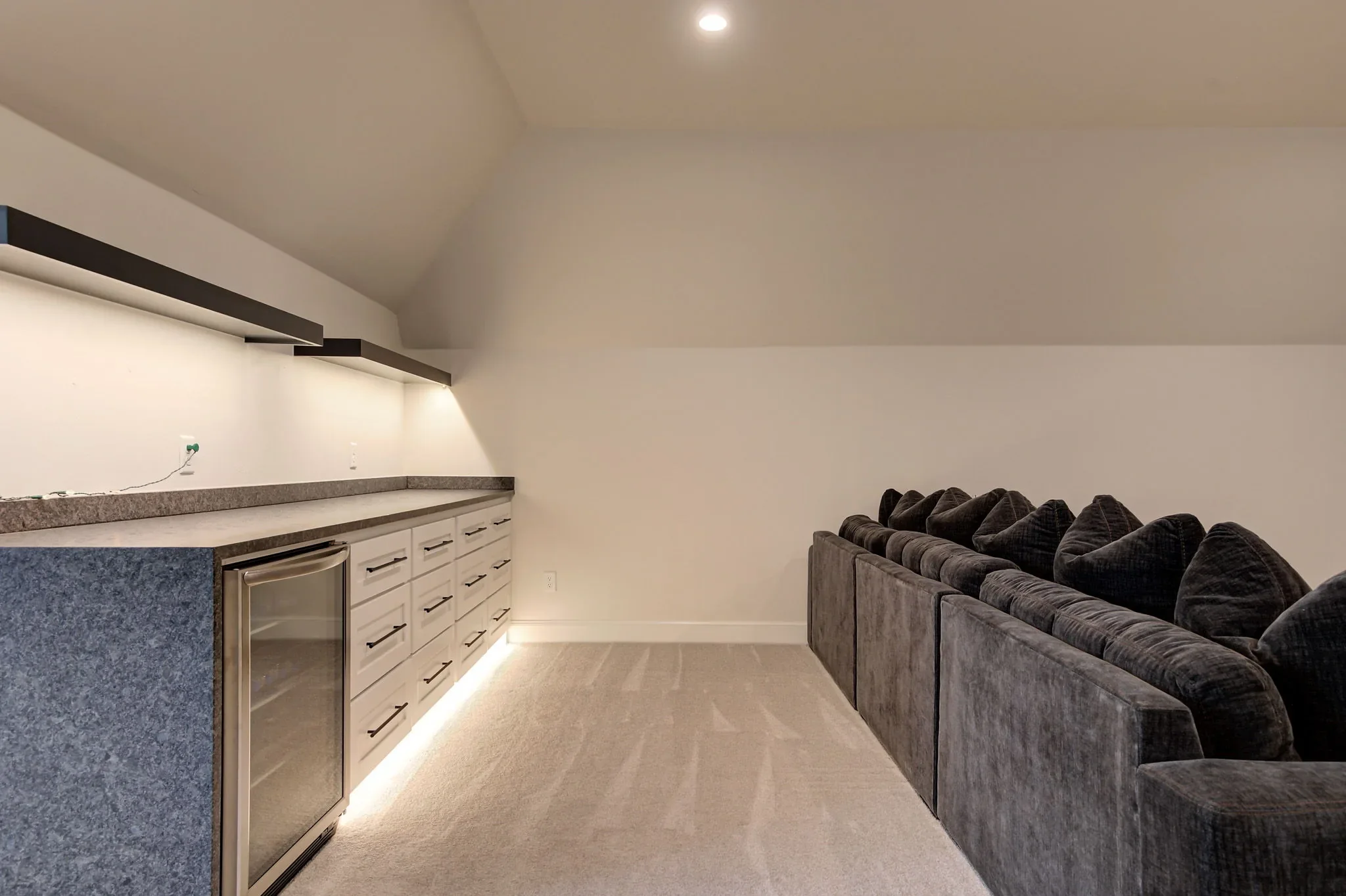 Upstairs media room wet bar with under-counter refrigerator