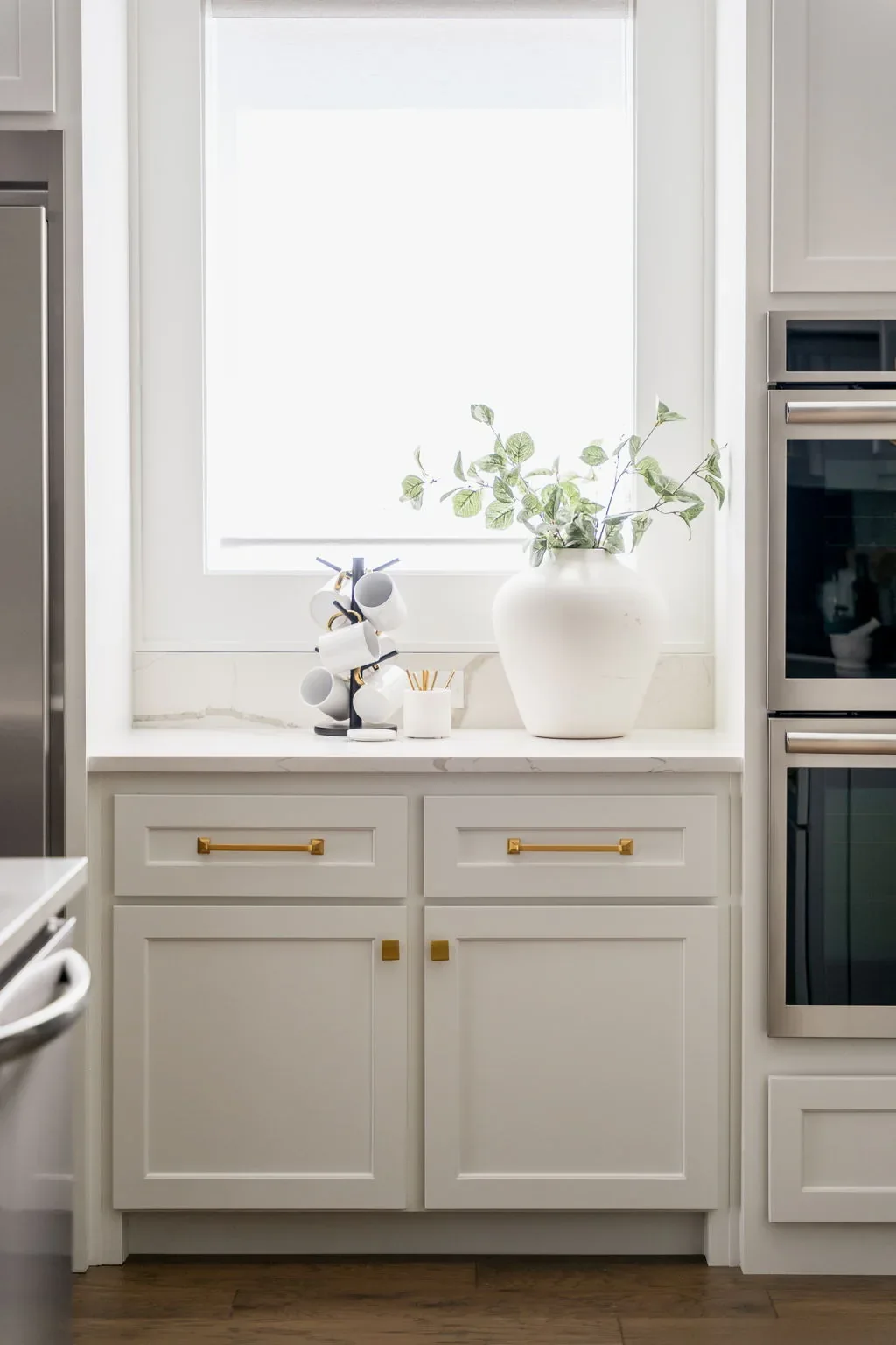Kitchen coffee station between the refrigerator and double ovens