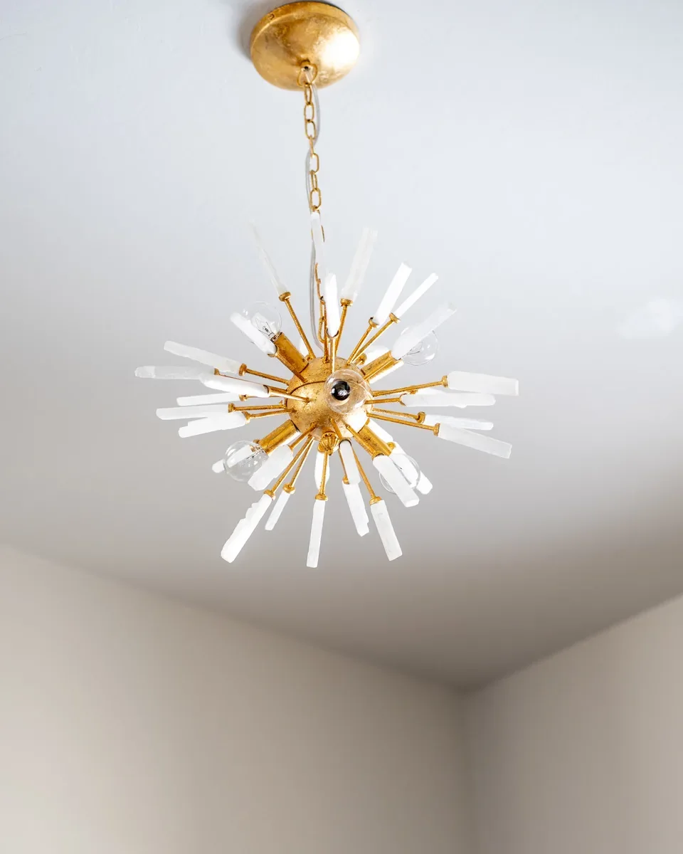 Gold starburst chandelier beneath the vaulted ceiling