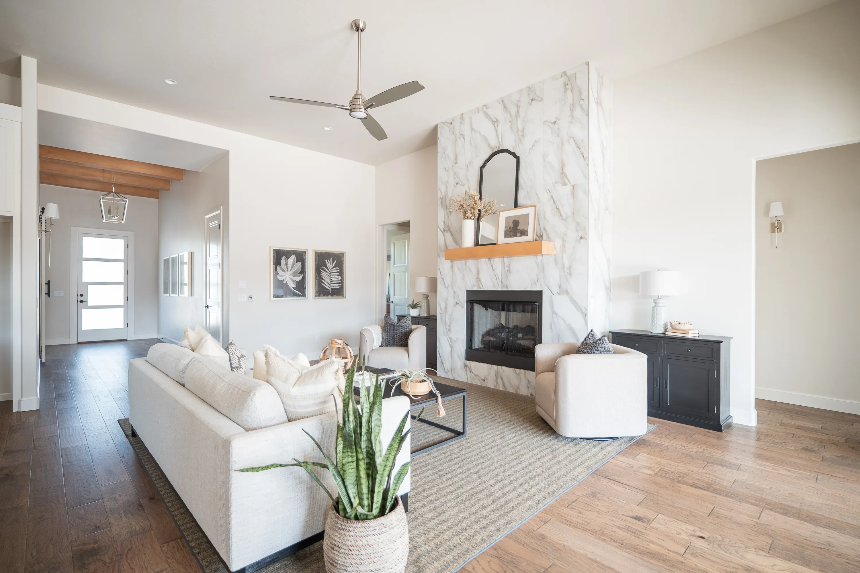 Living room with floor-to-ceiling tiled fireplace and floating mantel