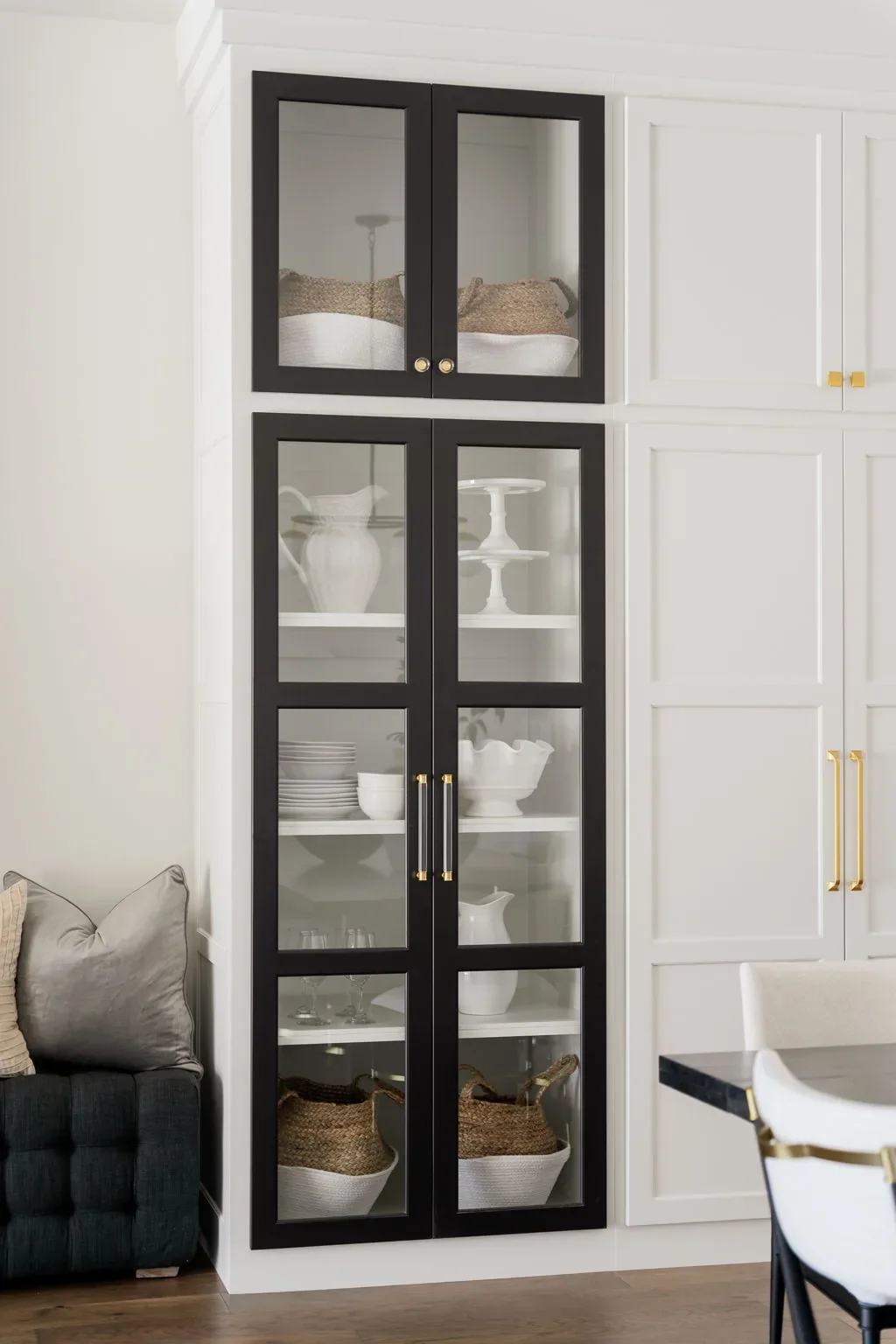 Black-framed glass display cabinet beside the dining area