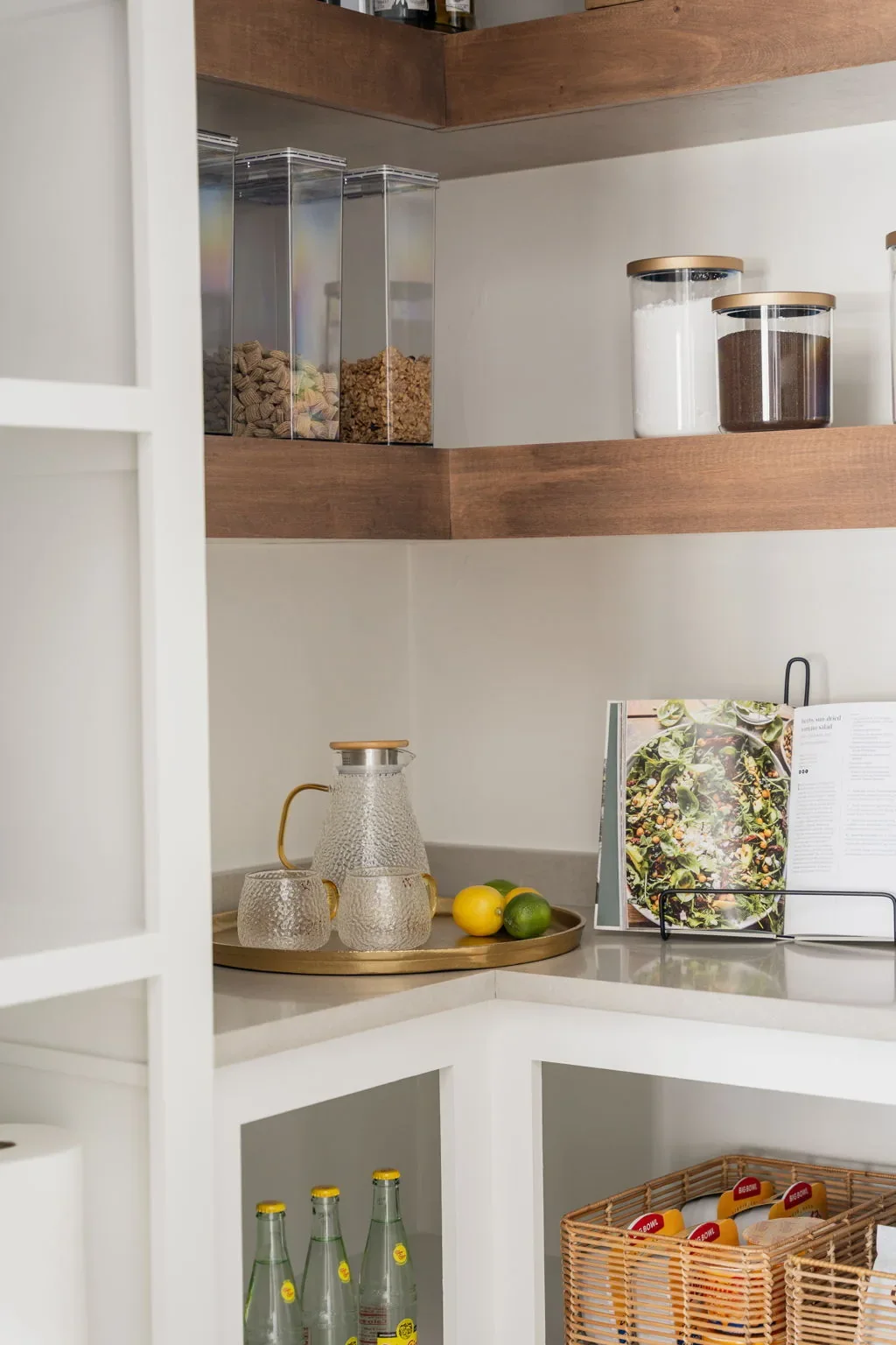 Walk-in pantry corner with wood shelving and white counters