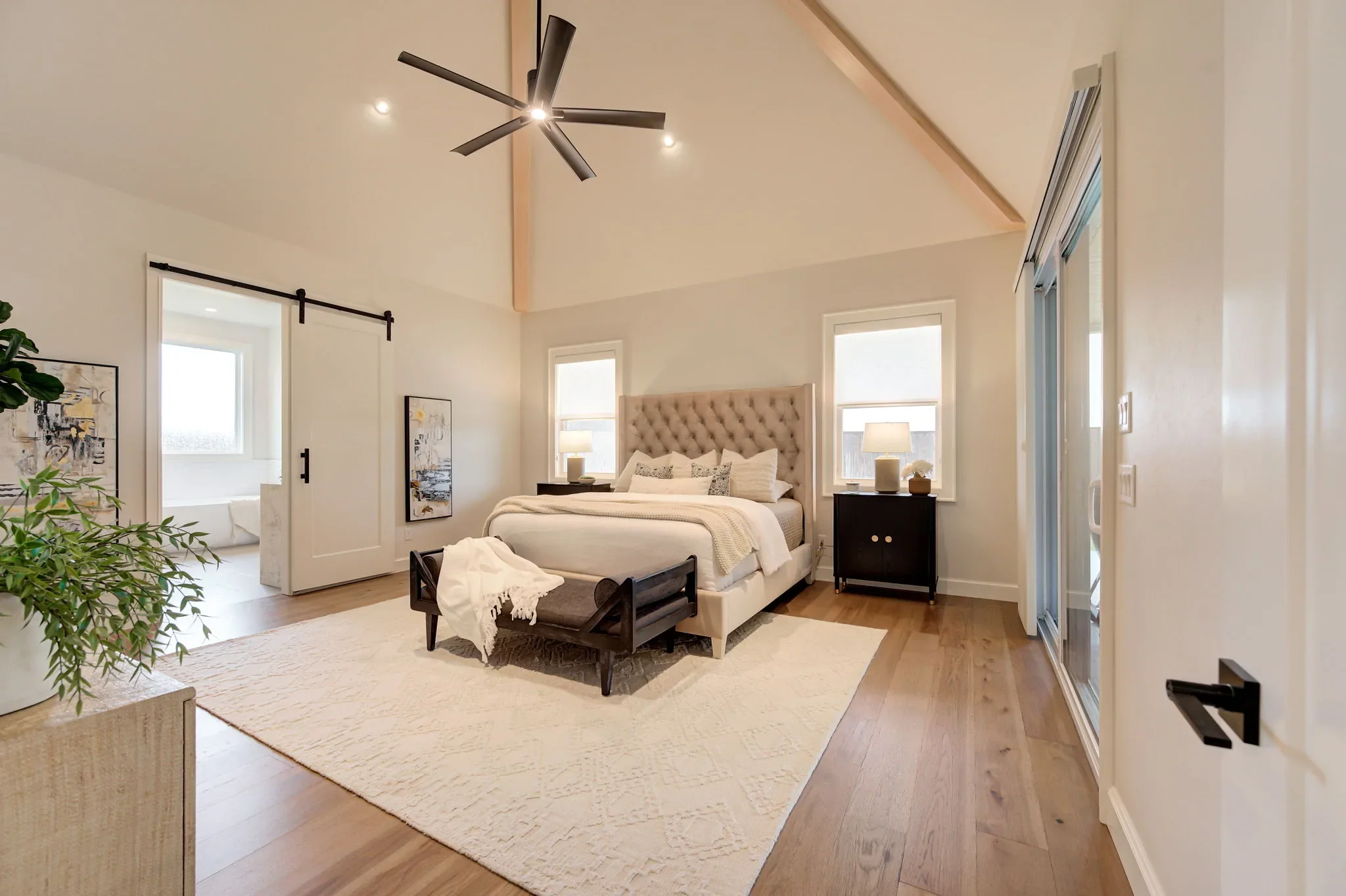 Primary bedroom with vaulted ceiling and exposed wood beam