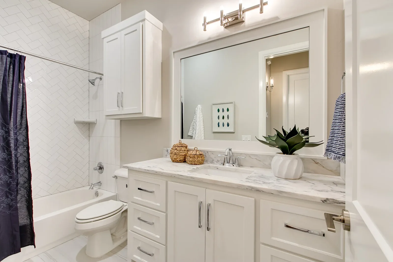 Guest bathroom with tub-shower and white vanity