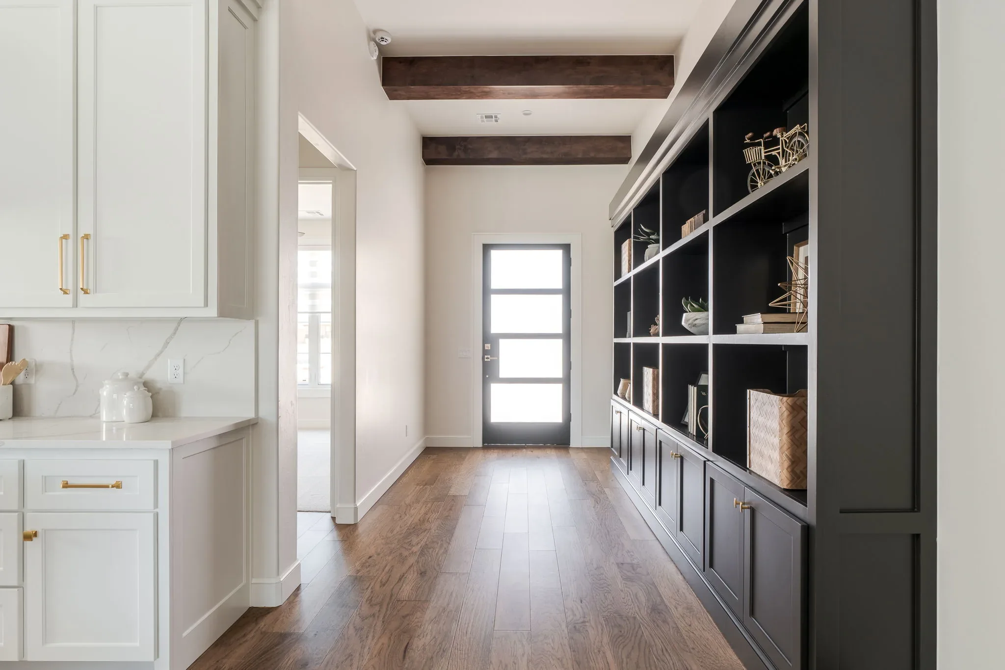 Mudroom hall with black built-in storage and ceiling beams