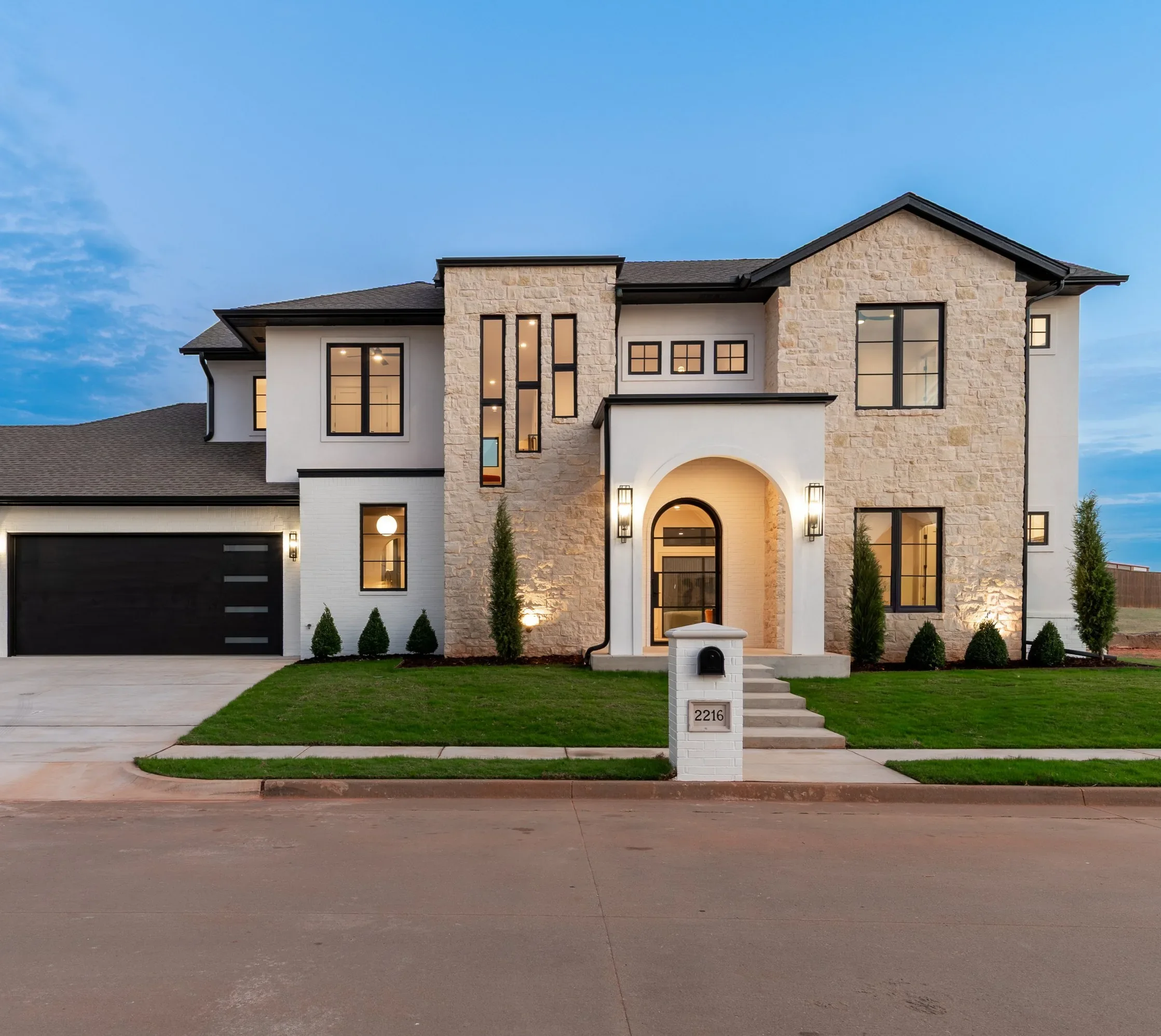 A completed Travis Horton Homes custom home at blue hour
