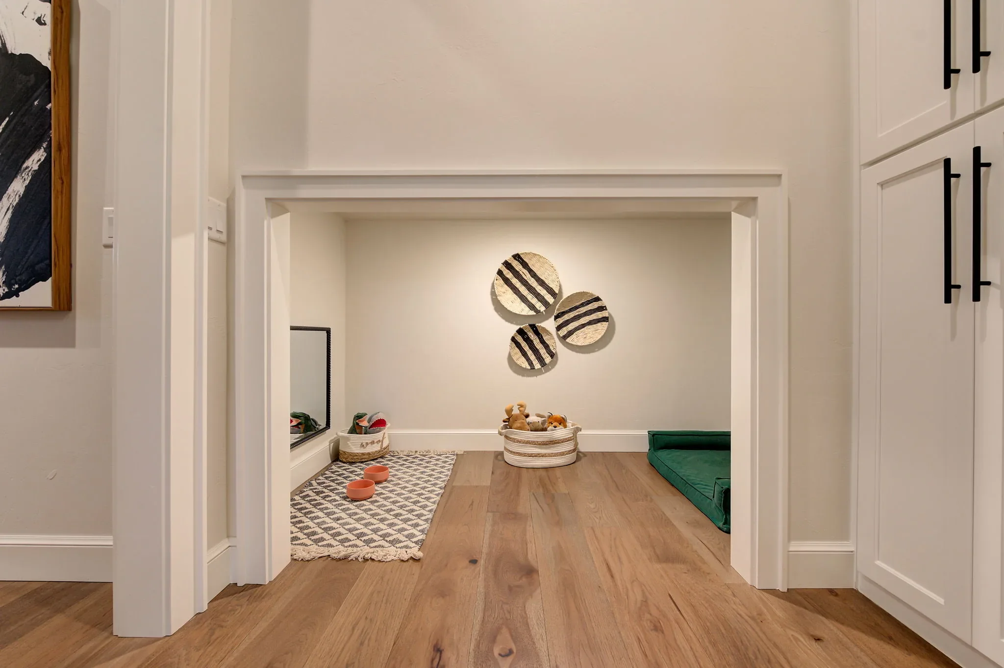 Built-in pet nook with beds and storage cabinetry
