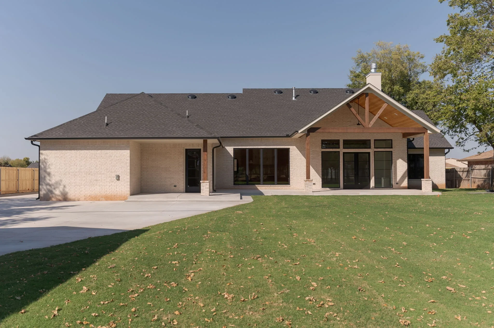 Rear exterior of 1154 Moose St with a covered patio and broad lawn