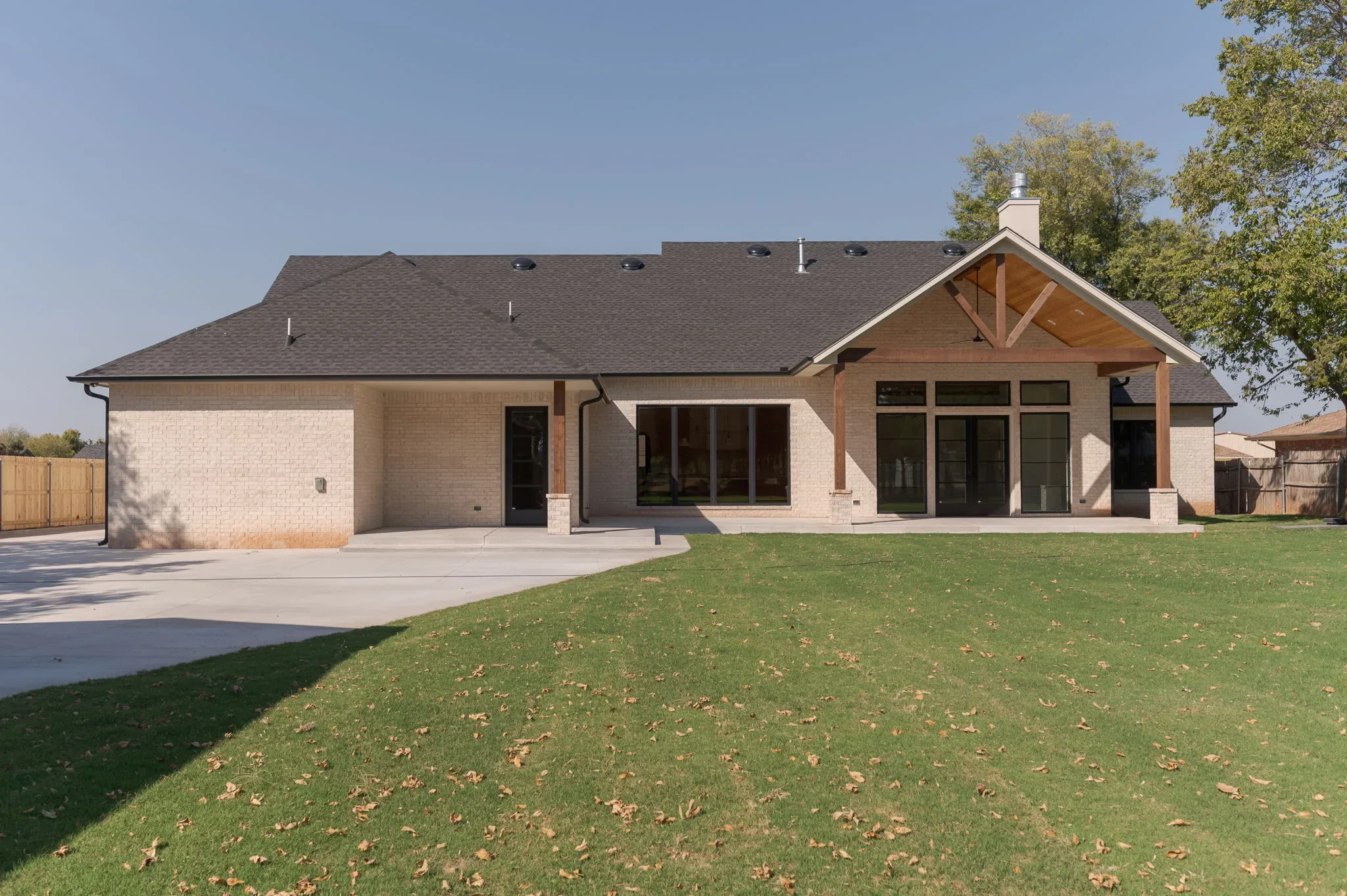 Rear exterior of 1154 Moose St with a covered patio and broad lawn